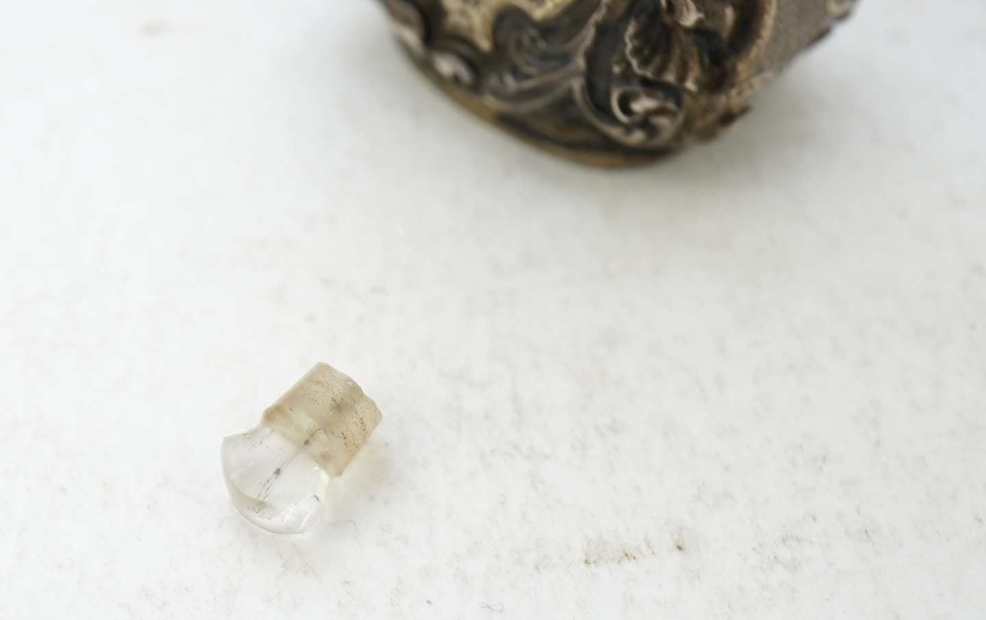 A 19th century French ornate parcel gilt white metal scent flask, with hinged cover and glass stopper